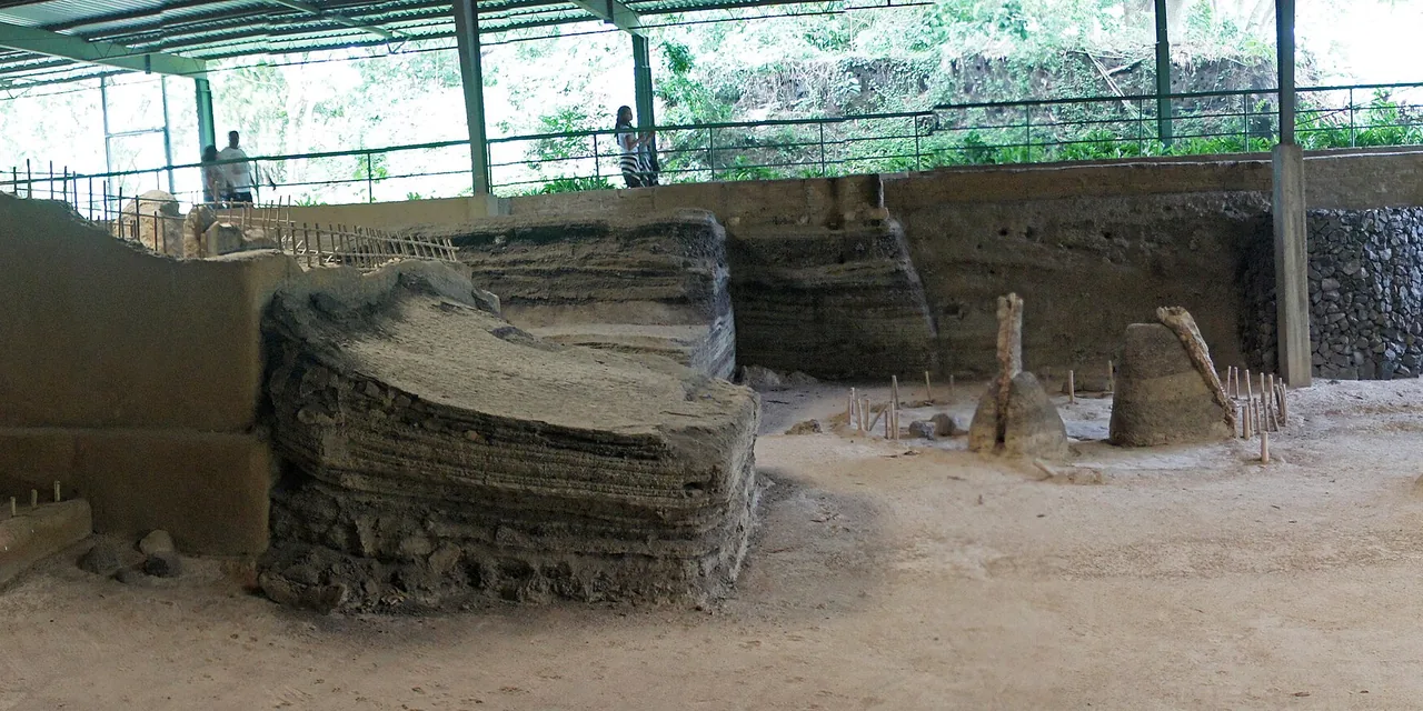 Protected earthen household structures and visitor walkway at Joya de Cerén