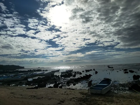 Fishing boats among rocks on the low-tide shore at Los Cóbanos