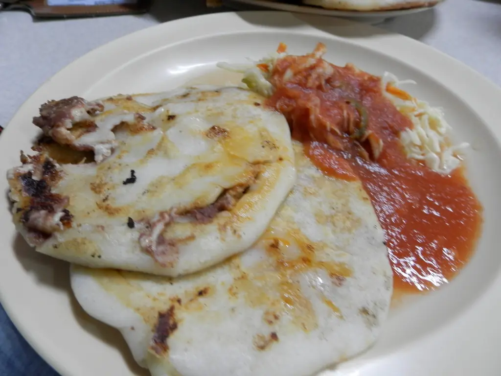 Pupusas served with curtido and salsa